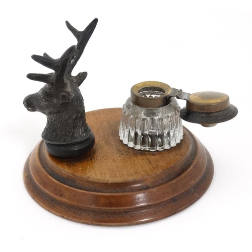 798 - A Desk top Standish the pen rest formed from a cast stag head  with glass ink bottle mounted upon a ... 