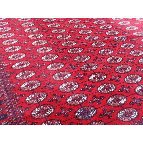 80 - Rug / Carpet :   A large woollen Bokara Rug with wine red ground , 133 (7x19) boteh to middle , Rug ... 