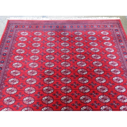 80 - Rug / Carpet :   A large woollen Bokara Rug with wine red ground , 133 (7x19) boteh to middle , Rug ... 