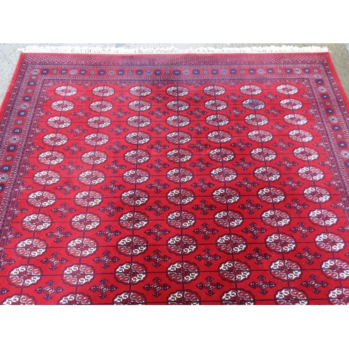 80 - Rug / Carpet :   A large woollen Bokara Rug with wine red ground , 133 (7x19) boteh to middle , Rug ... 