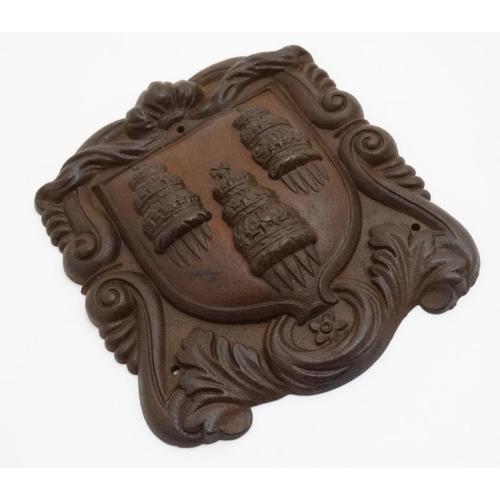 802 - A patinated cast iron armorial with shield having 3 towers to centre. 10'' high x 8 1/2'' wide