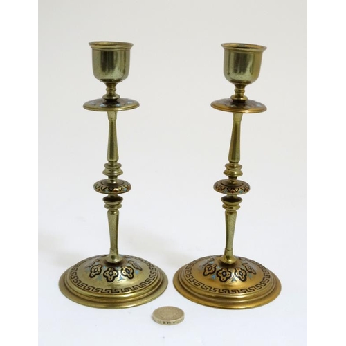 816 - A pair of 19thC Arts and Crafts brass and enamel turned candlesticks. 7 1/2'' high