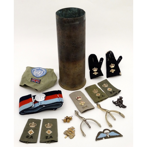 334 - Militaria : A collection of 20thC Military items , comprising a 105mm cannon shell ( inert ) from th... 