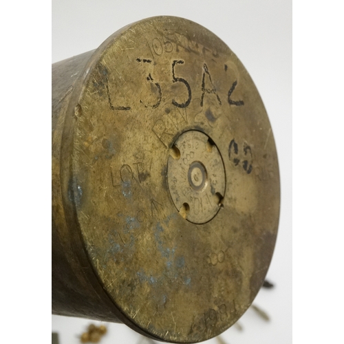 334 - Militaria : A collection of 20thC Military items , comprising a 105mm cannon shell ( inert ) from th... 