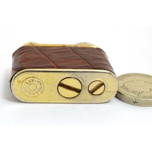 820 - A vintage cigarette lighter by Bric Lux of Paris with gilded and crock skin envelope like covering 1... 