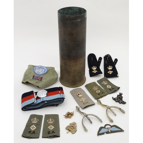 334 - Militaria : A collection of 20thC Military items , comprising a 105mm cannon shell ( inert ) from th... 