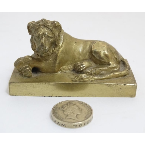 822 - An early 19thC gilt bronze cast lion on squared socle. 3'' long