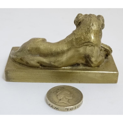 822 - An early 19thC gilt bronze cast lion on squared socle. 3'' long