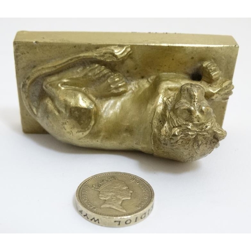 822 - An early 19thC gilt bronze cast lion on squared socle. 3'' long