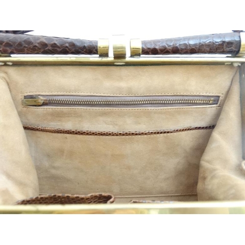 831 - A vintage crocodile effect leather brown ladies single handle handbag, with brass hardware and frame... 