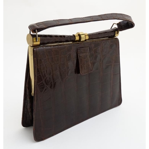 831 - A vintage crocodile effect leather brown ladies single handle handbag, with brass hardware and frame... 