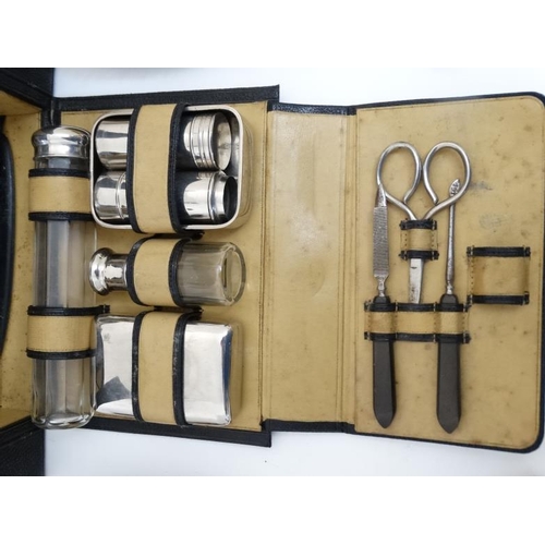 846 - An early - mid 20thC black leather and pigskin lined Gentleman's travelling vanity set with ebony an... 