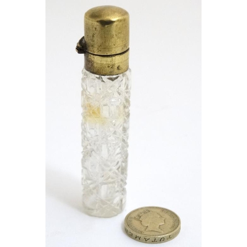 848 - A late Victorian brass topped glass scent bottle with hobnail like cut decoration. the whole 3 3/8''... 