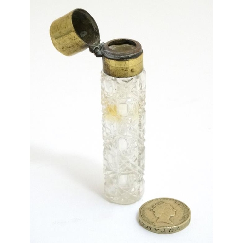 848 - A late Victorian brass topped glass scent bottle with hobnail like cut decoration. the whole 3 3/8''... 