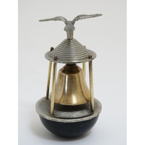 856 - A 20thC novelty desk bell in the form of a seabird above a buoy bears reg design number under 5 1/2'... 