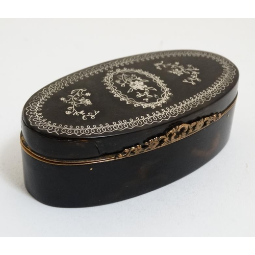 857 - A 19thC tortoiseshell silver inlaid hinged lidded box with silver gilt facings. 3 1/2'' long x 1 1/4... 