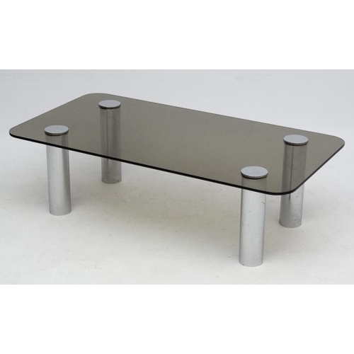 86 - Vintage Retro :   A Modernist smoked glass top low table with four cylindrical chrome legs measuring... 