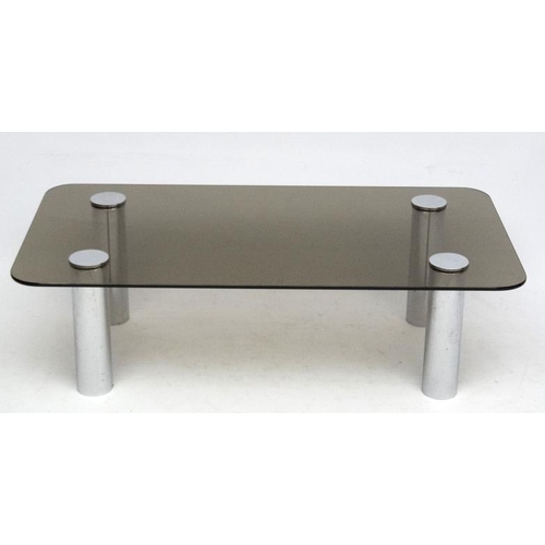 86 - Vintage Retro :   A Modernist smoked glass top low table with four cylindrical chrome legs measuring... 