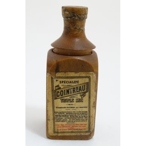 862 - Cointreau Tripple Sec - A novelty carved miniature boxwood bottle shaped container unscrewing to rev... 