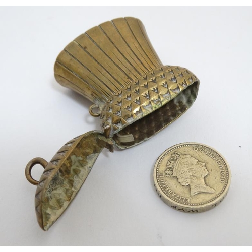 864 - A brass vesta / match holder formed as a Scottish thistle head with hinged top with hinged top. 2'' ... 