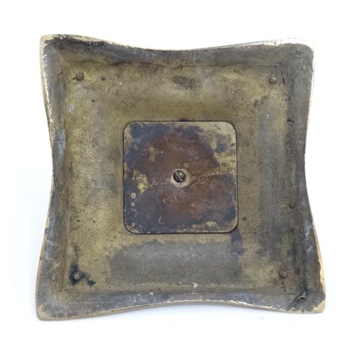 877 - A 19thC cast brass inkwell with pen rests, the centre hinging open to reveal glass lined inkstand. 6... 