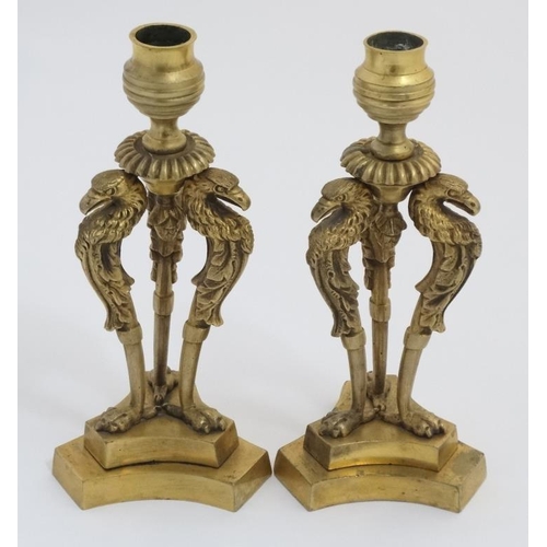 889 - A pair of Regency tri-form gilt brass candlesticks with three bird caryatids. 8 1/2'' high