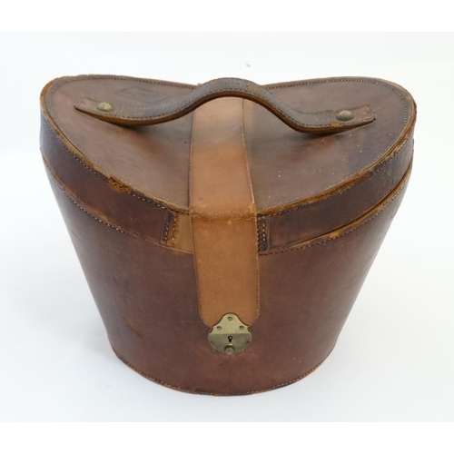 894 - A mid 20thC '' Brooks Brothers '' brown leather saddle shaped hat box with red silk lining , made by... 