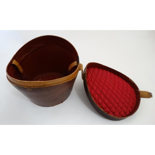 894 - A mid 20thC '' Brooks Brothers '' brown leather saddle shaped hat box with red silk lining , made by... 