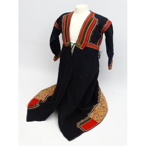 895 - A Yugoslavian felted blue/black wool coat, with chain stitch detailed panels, rac ric braid and embr... 