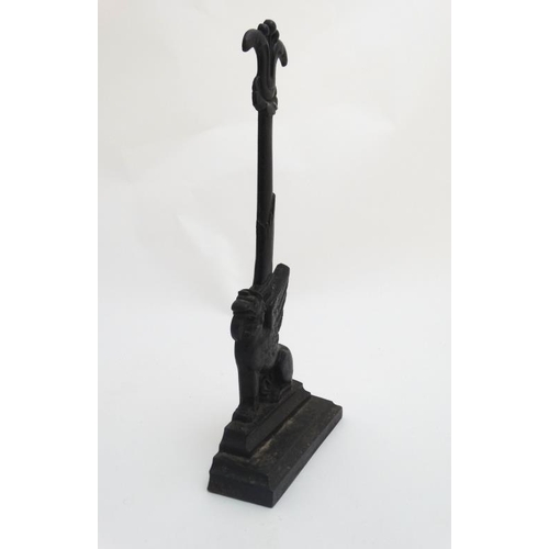 902 - A Victorian cast iron door porter / door stop in the form of a Griffin on squared stand. 16 1/4'' hi... 