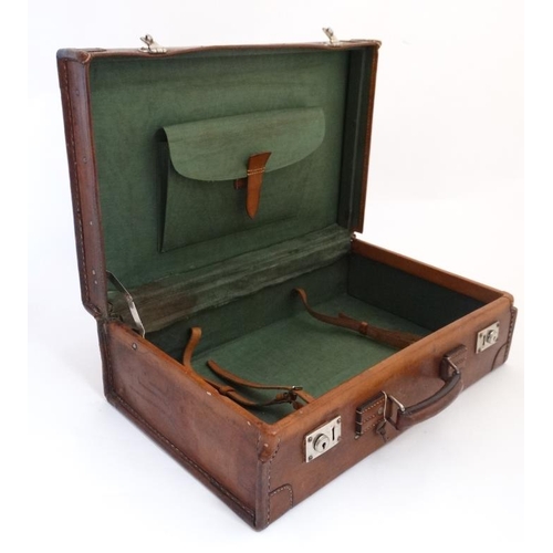 903 - A leather travelling case with watered green silk interior and pocket to lid 21 1/2'' wide