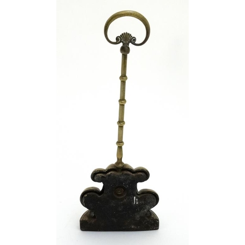 908 - A 19thC brass doorstop / porter with cast iron lead weight. Approx 15'' high