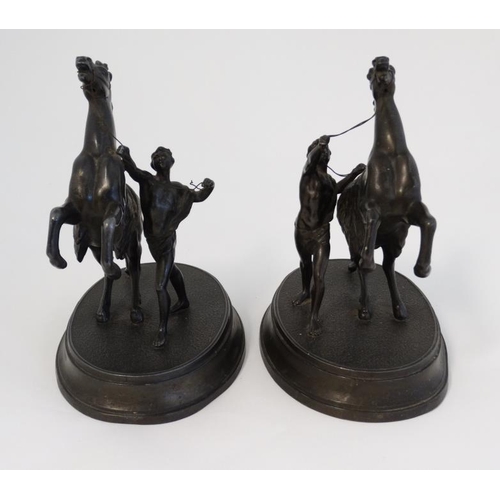 910 - Marley horseman : A  pair of Victorian spelter Marley Horseman figure groups on oval bases. 8 3/4'' ... 