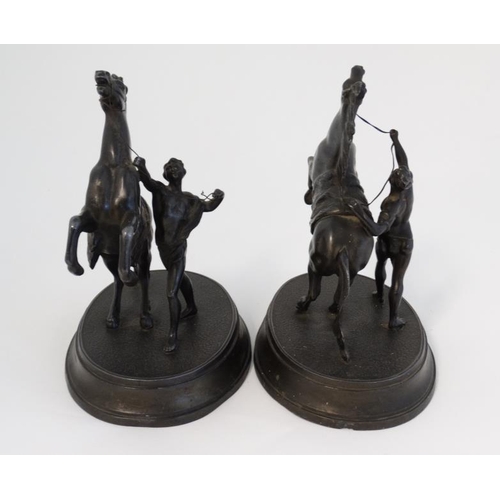 910 - Marley horseman : A  pair of Victorian spelter Marley Horseman figure groups on oval bases. 8 3/4'' ... 