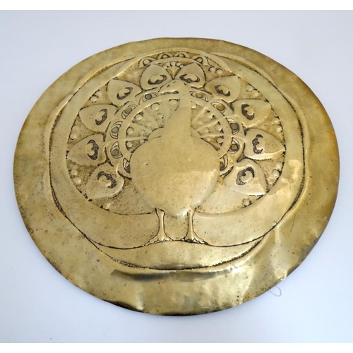 911 - Arts and Crafts : An embossed brass firescreen formed as a charger with peacock decoration  26 1/2''... 