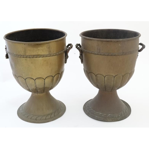 913 - A pair of early 20thC brass urn shaped jardinieres with green man mask handles to sides. 13 1/'''' h... 