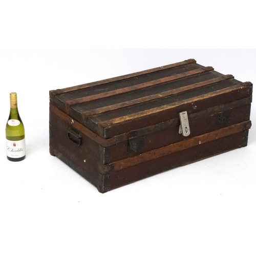 926 - A c.1900 canvas and wooden bound travelling trunk opening to reveal a fabric lined interior. 30 1/2'... 