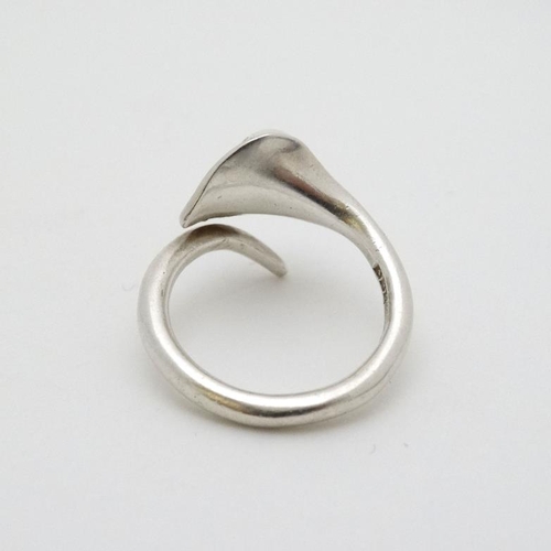 937 - A hallmarked silver ring formed as a stylised calla lily with pearl decoration. Maker ARC