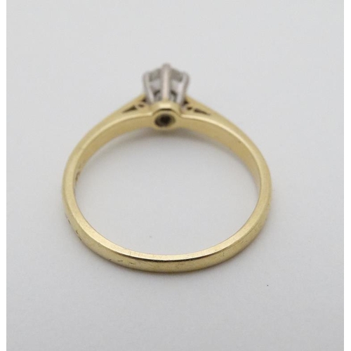 938 - An 18ct gold ring set with diamond solitaire