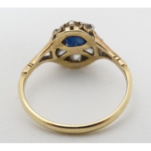 945 - An 18ct gold ring set blue stone and diamonds in a platinum setting