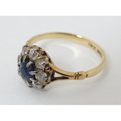 945 - An 18ct gold ring set blue stone and diamonds in a platinum setting