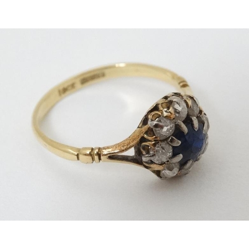 945 - An 18ct gold ring set blue stone and diamonds in a platinum setting