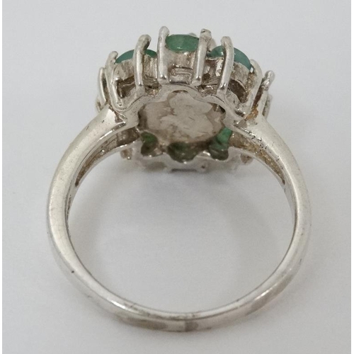 946 - A silver ring set with green stones and marcasites