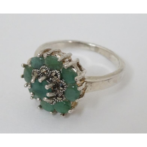 946 - A silver ring set with green stones and marcasites