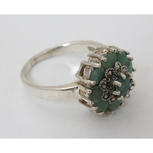 946 - A silver ring set with green stones and marcasites