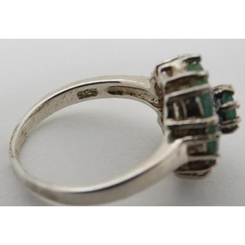 946 - A silver ring set with green stones and marcasites