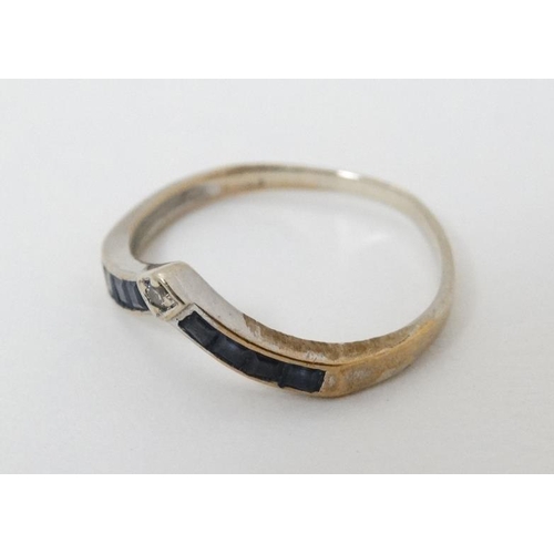 947 - A 14ct gold ring set with white and blue stones