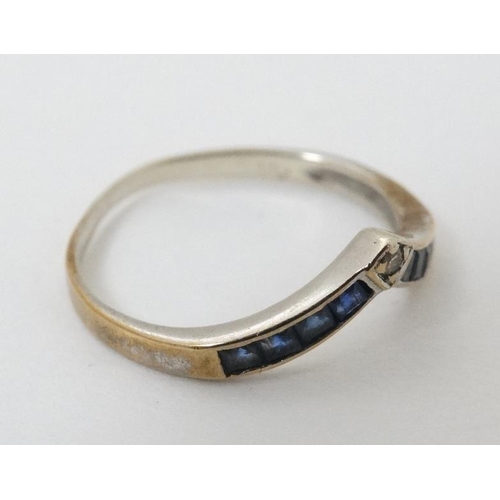 947 - A 14ct gold ring set with white and blue stones