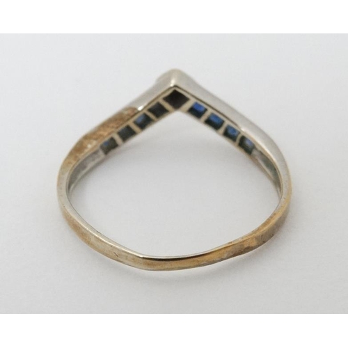 947 - A 14ct gold ring set with white and blue stones