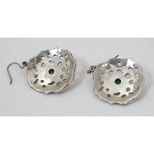 954 - A pair of silver drop earrings of abstract form set with central green stone. 1 1/4'' wide